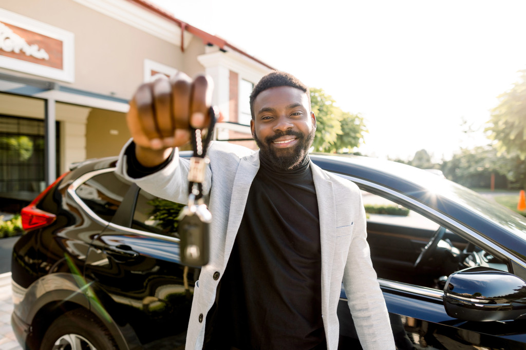 A traveler collecting rental car keys